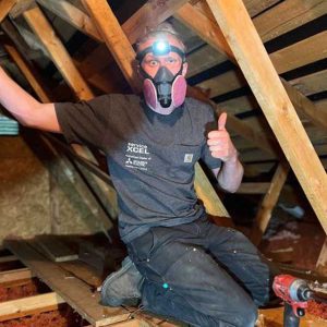 ServiceXCEL tech working in attic thumbs up