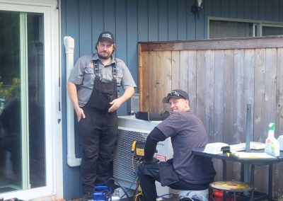 ServiceXCEL technicians working on heat pump