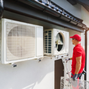 Caucasian Professional HVAC Technician Performing Air Condition and Heat Pump Units Maintenance
