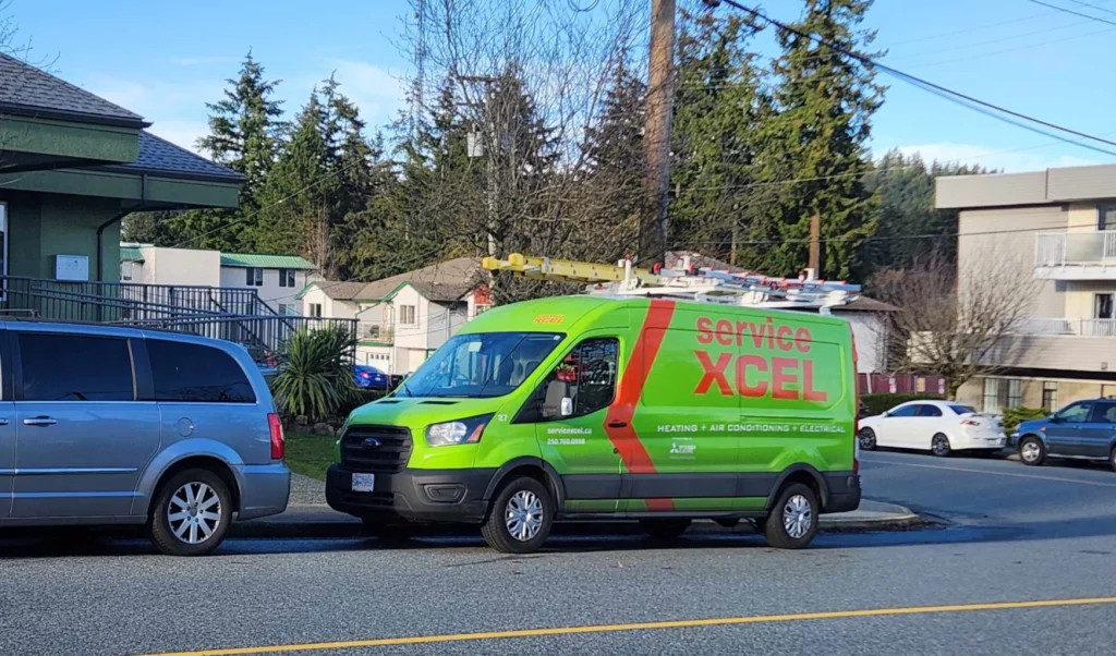 Green Service Xcel van advertising heating, air conditioning, and electrical services, parked on a residential street