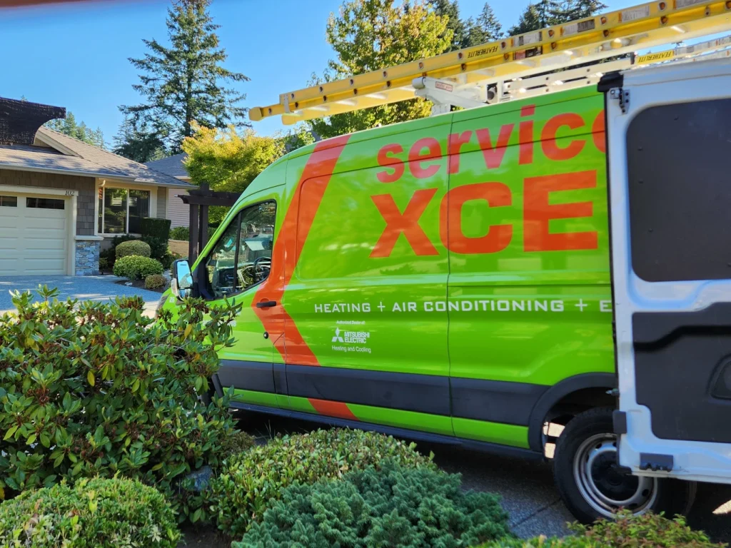 Green and orange heating and air conditioning service van with a ladder parked outside a house